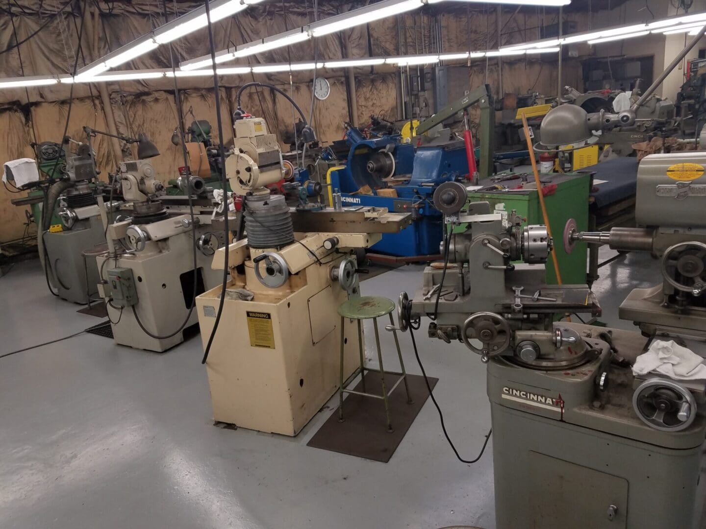 A workshop filled with various machinery and tools for manufacturing or repair work.