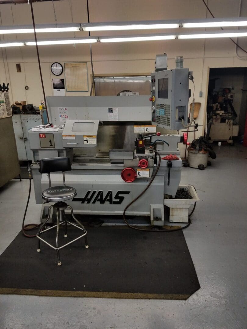 Industrial HAAS milling machine in a workshop setting.
