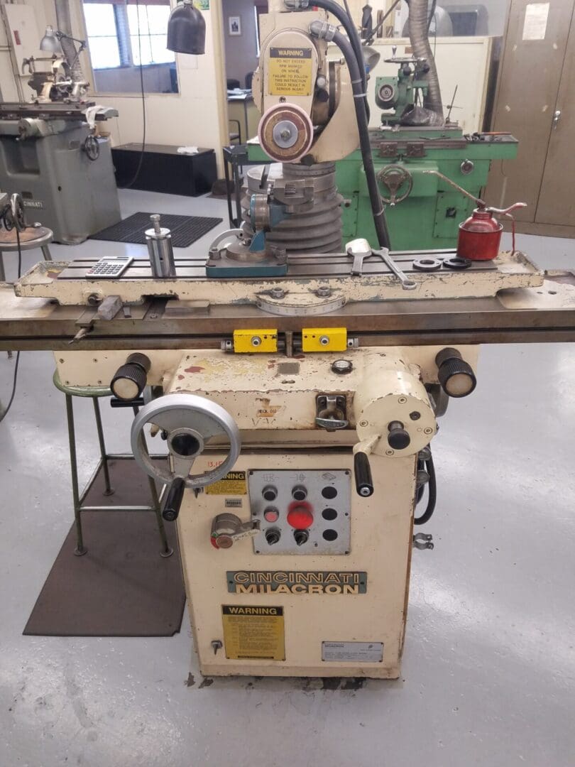 Vintage metal milling machine in a workshop setting.